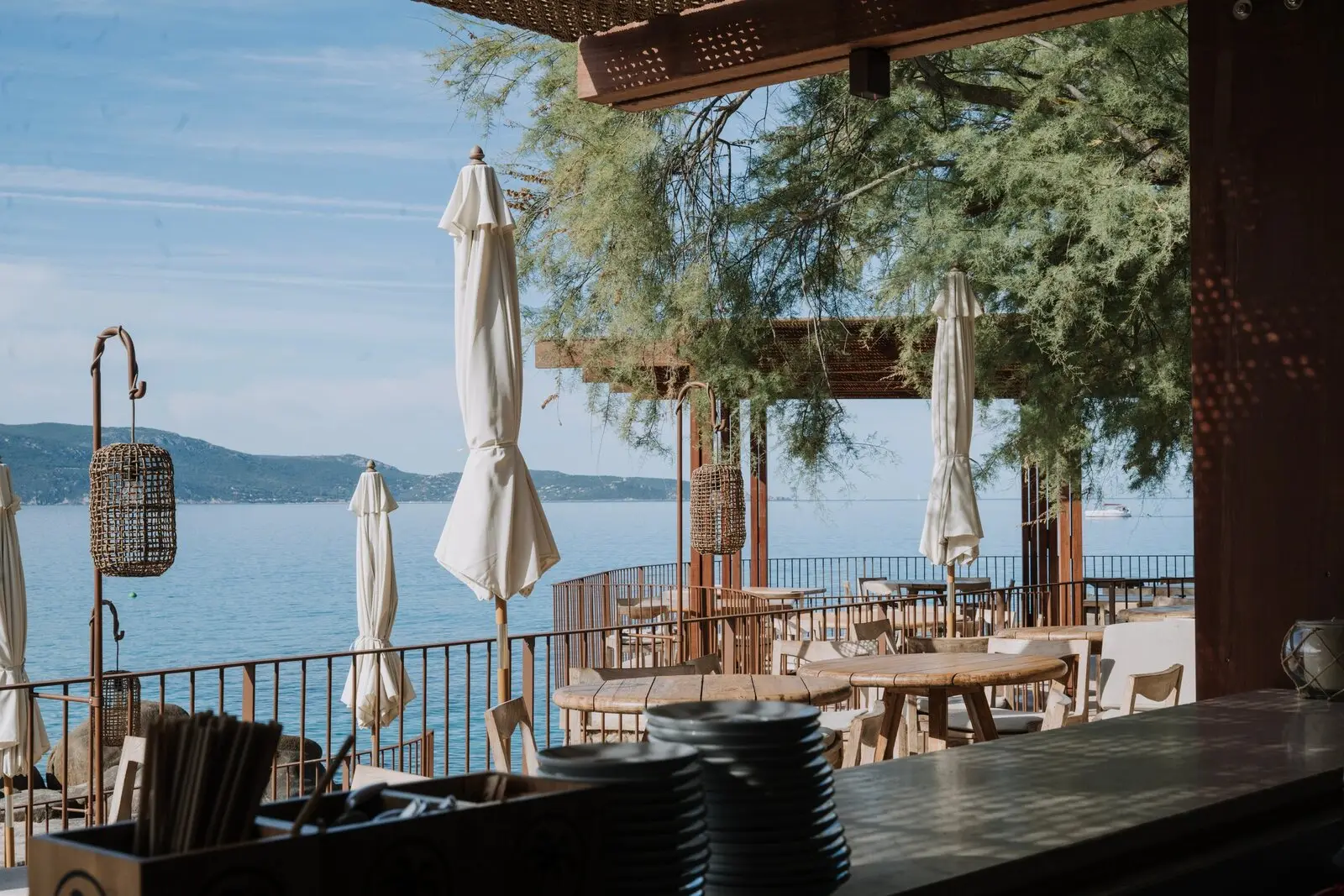 The waterfront restaurant terrace under the tamaris